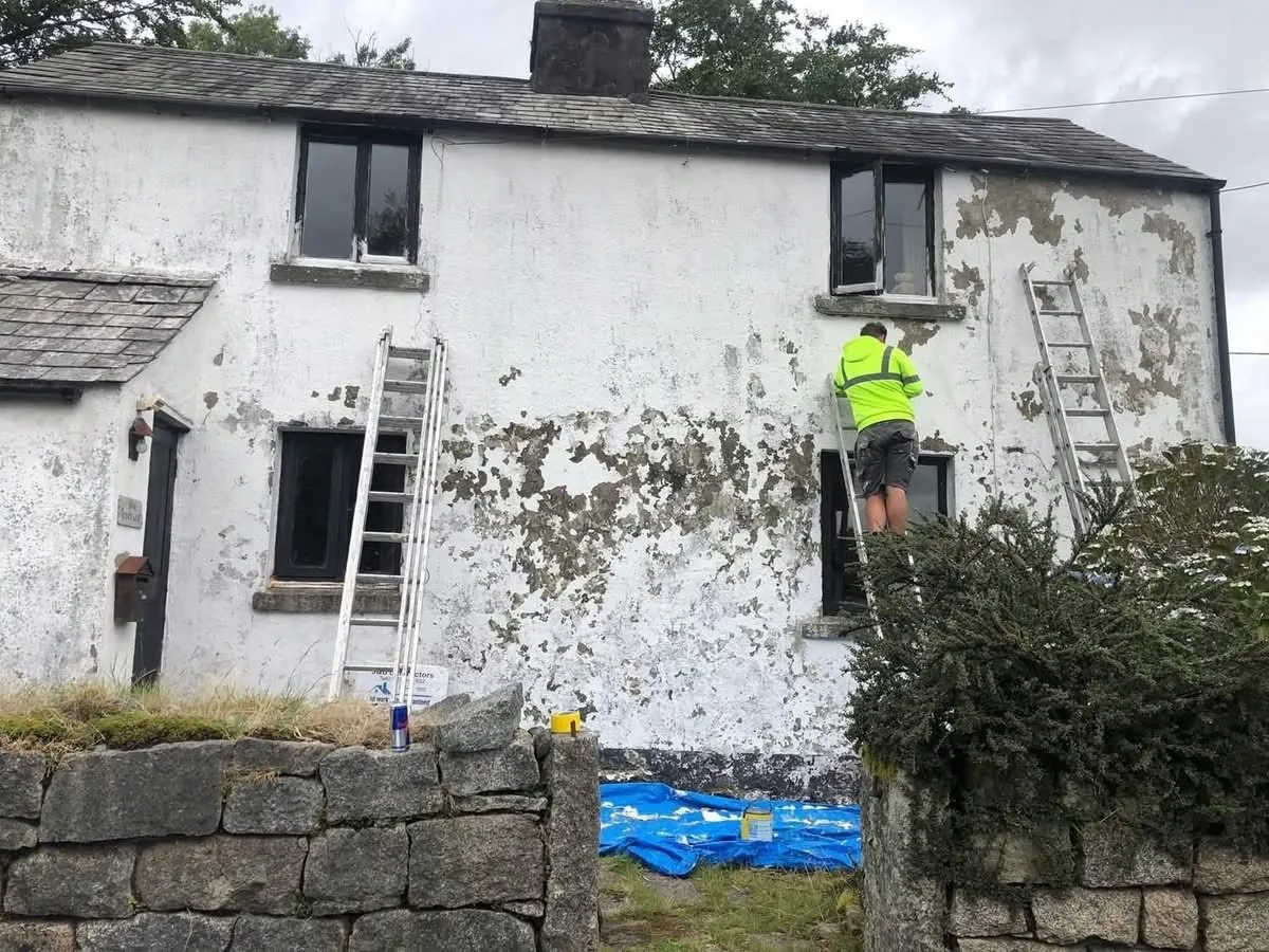 Cottage with blown, flaking render before repair in Redruth